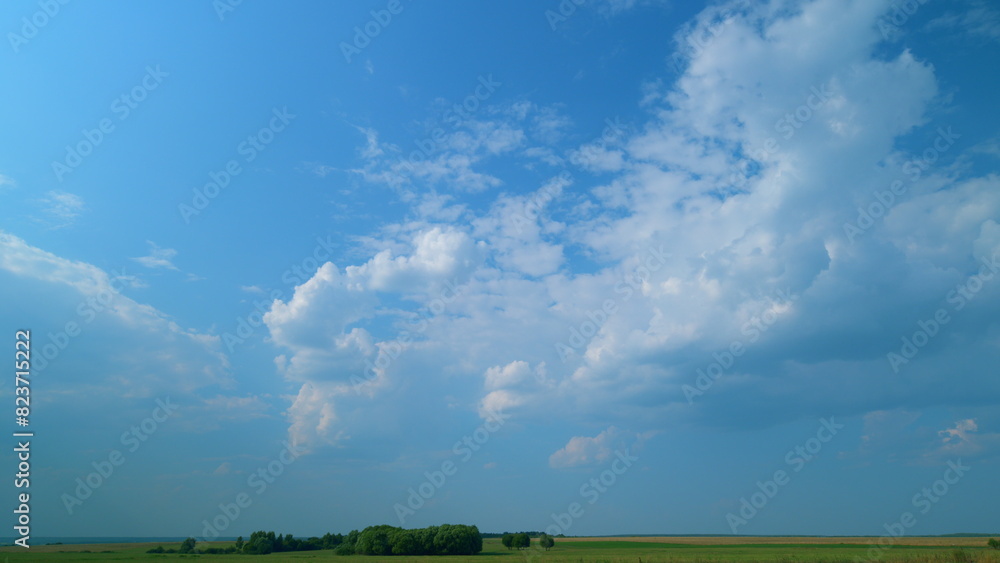 Fluffy curly rolling cloud in windy weather. Blue sky white clouds. Time lapse.