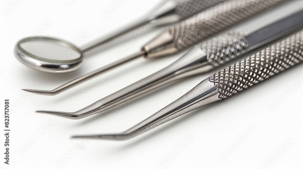 A close-up of dental tools arranged on a white surface A close-up of dental tools arranged on a white surface