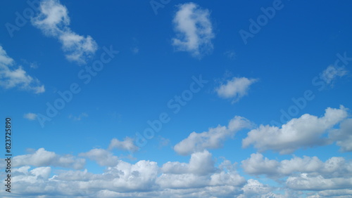 Clear gradient blue sky in tropical summer sunlight. Beautiful sunny clear blue sky in tropical summer with cumulus and cirrus on different layers clouds. Timelapse. photo
