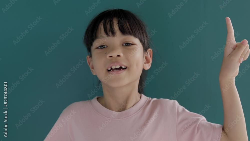 Close-up Portrait Video Asian Thai kid girl, 8 to 10 years old, with beautiful long hair. She is making gestures showing her thoughts to answer questions in learning. The background is green screen Close-up Portrait Video Asian Thai kid girl, 8 to 10 years old, with beautiful long hair. She is making gestures showing her thoughts to answer questions in learning. The background is green screen