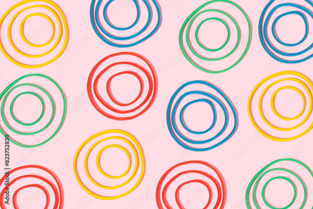 Colourful rubber bands on bright pink background. Creative composition, minimal concept. Seamless pattern. Colourful rubber bands on bright pink background. Creative composition, minimal concept. Seamless pattern.