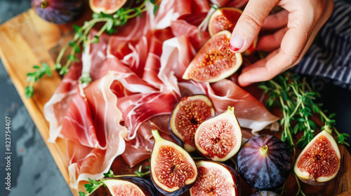 A cutting board displaying a variety of figs and meats photo