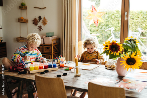 Kids painting at home together photo