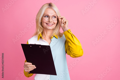 Photo of nice aged lady clipboard look empty space wear shirt isolated on pink color background