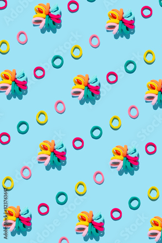 Abstract composition made of colourful hair bands on bright background.