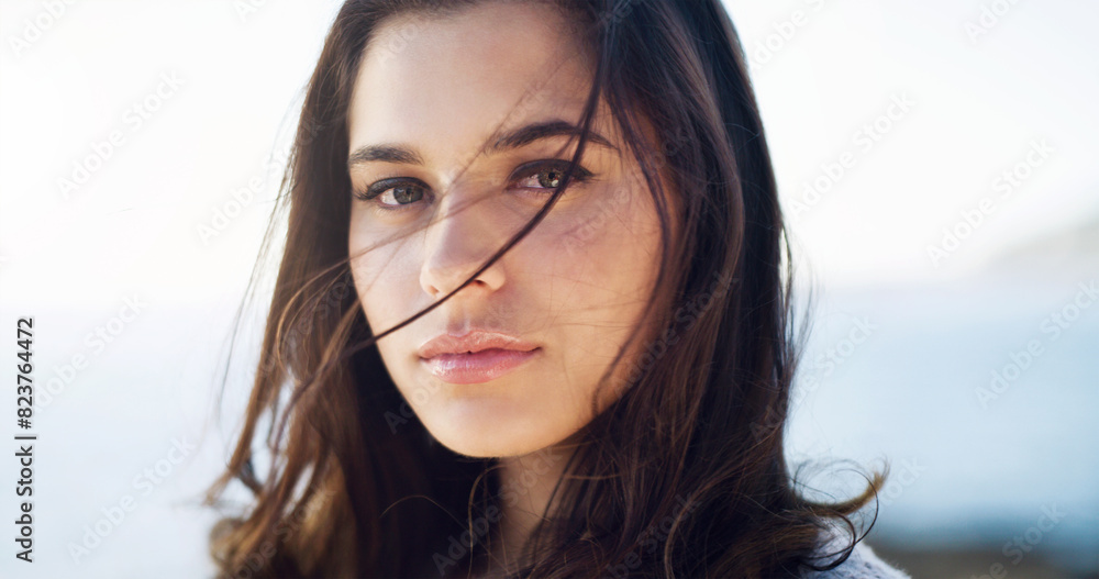 Woman, portrait and serious for travel outdoor on holiday, vacation and summer adventure to relax. Person, face and tourist with confidence by beach for fresh air, weekend break and pride at seaside Woman, portrait and serious for travel outdoor on holiday, vacation and summer adventure to relax. Person, face and tourist with confidence by beach for fresh air, weekend break and pride at seaside