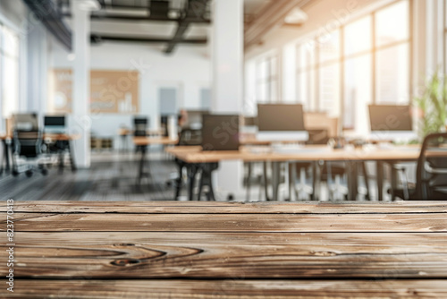 A wooden tabletop in the foreground with a blurred background of a high-tech office. The background features modern workstations with multiple monitors  ergonomic chairs  and whiteboards.