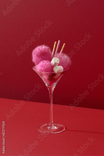 The cocktail is decorated with marshmallow candies and cotton candy photo