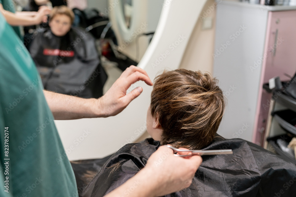 Barber with giving boy haircut Barber with giving boy haircut