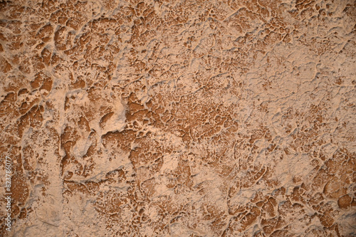 Textured background of brown and beige plaster