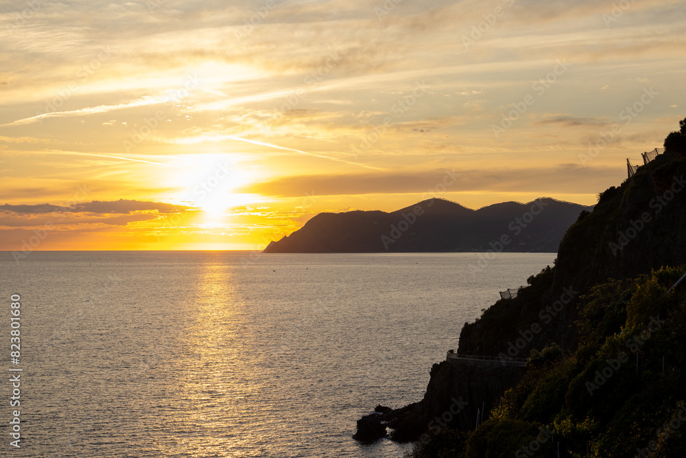 sunset over the sea with mountain in the background in cinque-terre italy sunset over the sea with mountain in the background in cinque-terre italy