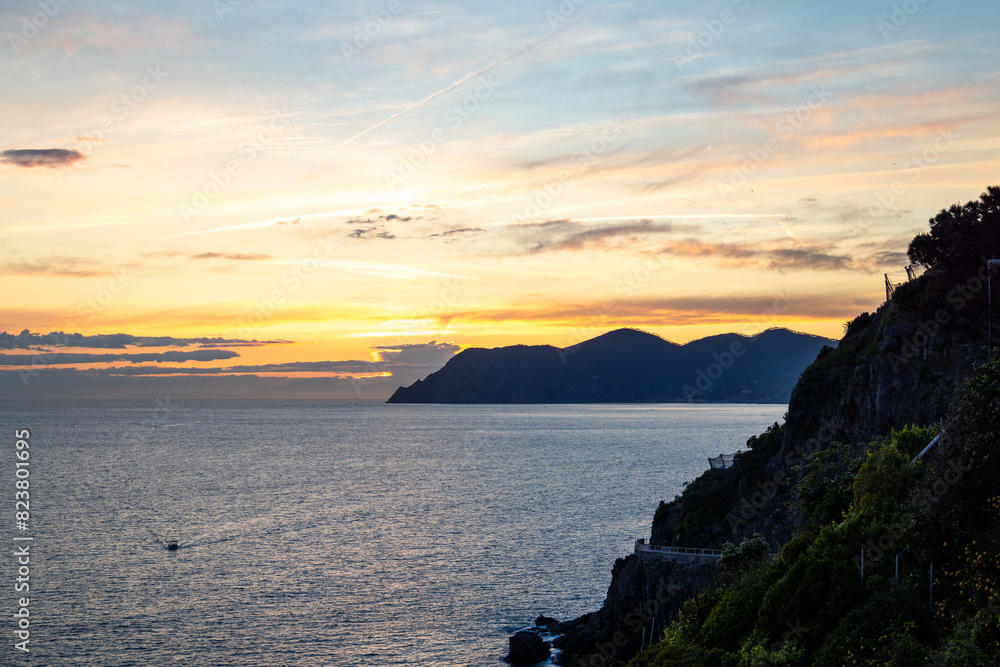 sunset over the sea with mountain in the background in cinque-terre italy sunset over the sea with mountain in the background in cinque-terre italy