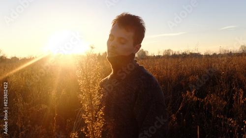 Serene Sunset Moment Captured as Man Meditates in Countryside photo