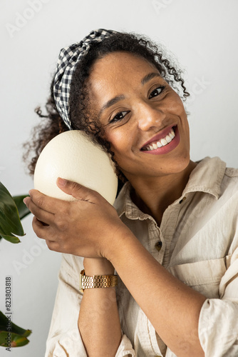 Smiling woman with egg. Mindfulness pratice. photo