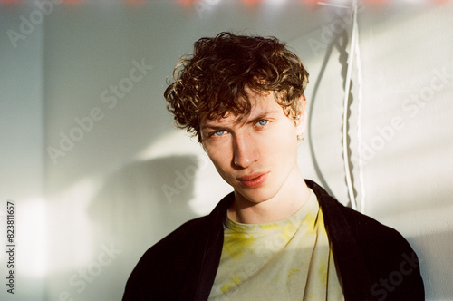 Portrait of a model with bedhead waking up in sunny room early morning photo