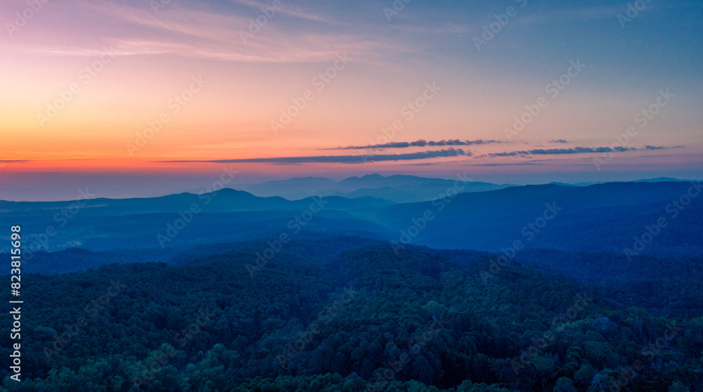 Aerial view of sunrise over mountian and pine tree in Chiang Mai Province, Thailand..