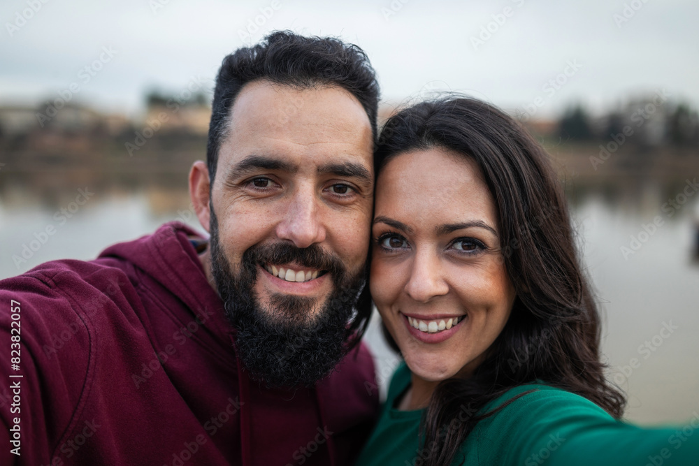 ugc of a couple taking a photo next to a river in the background ugc of a couple taking a photo next to a river in the background