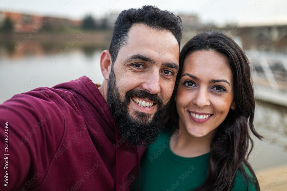 ugc of a couple taking a photo next to a river in the background ugc of a couple taking a photo next to a river in the background
