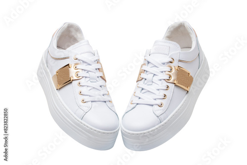 White sneaker isolated. Close-up of a pair white elegant stylish female leather high-heeled sport shoes isolated. Clipping path. Womens shoe fashion. Modern design footwear for workout.
