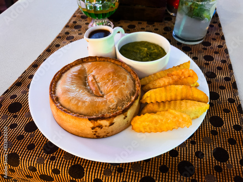 Chicken pie and chips with mushy peas