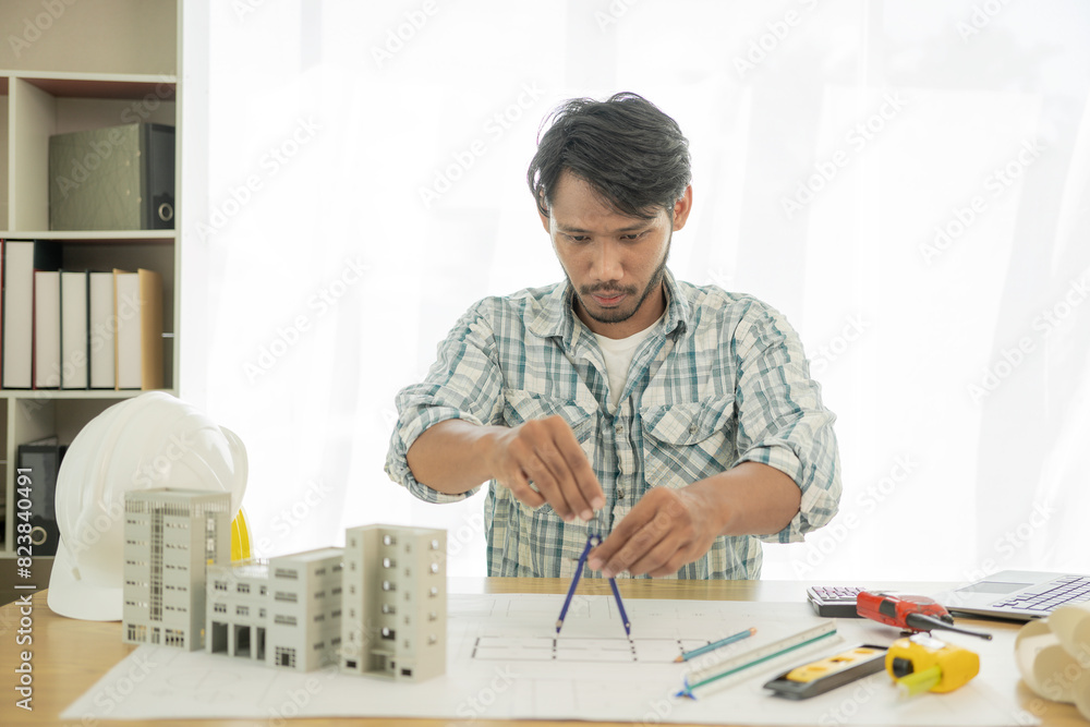 Architects studying floor plans, serious civil engineers working with documents on real estate construction, and professional foremen in home improvement: Architects studying floor plans, serious civil engineers working with documents on real estate construction, and professional foremen in home improvement: