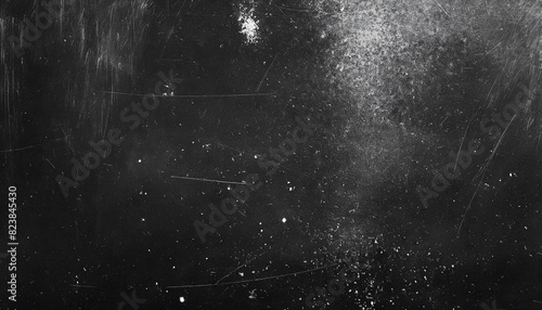 Black board with dust and scratches design, dark grunge abstract background and copy space photo