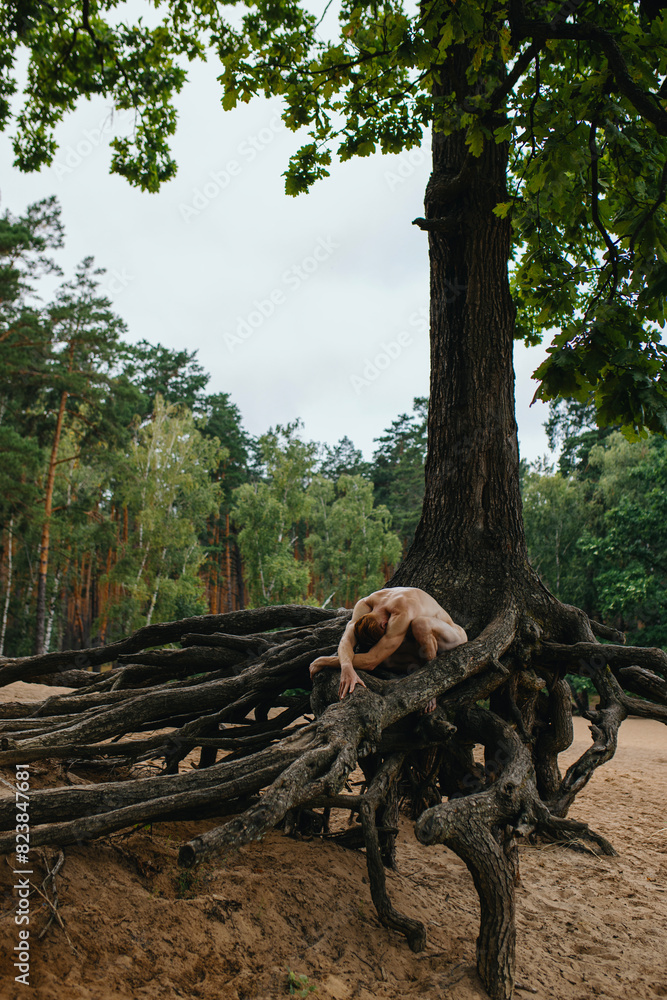 Redhead nude Man bare-chested athlete posing near tree roots outside Redhead nude Man bare-chested athlete posing near tree roots outside