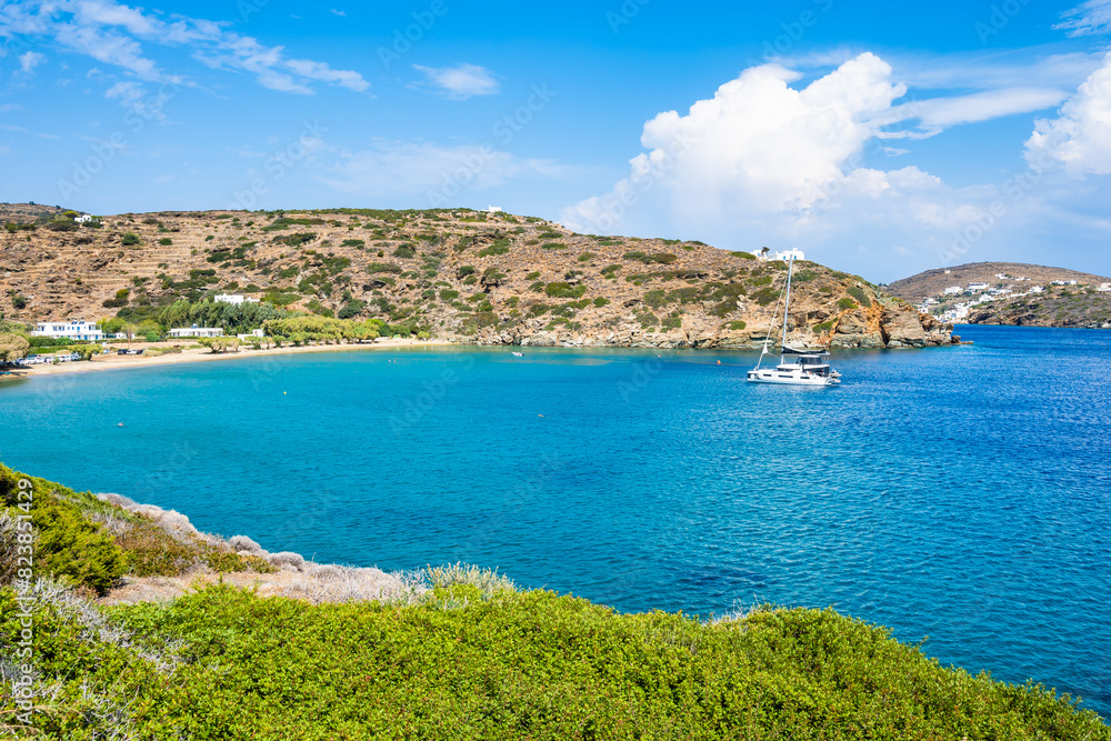 Idyllic view of catamaran boat in sea bay and green hills near Chrysopigi monastery, Sifnos island, Greece