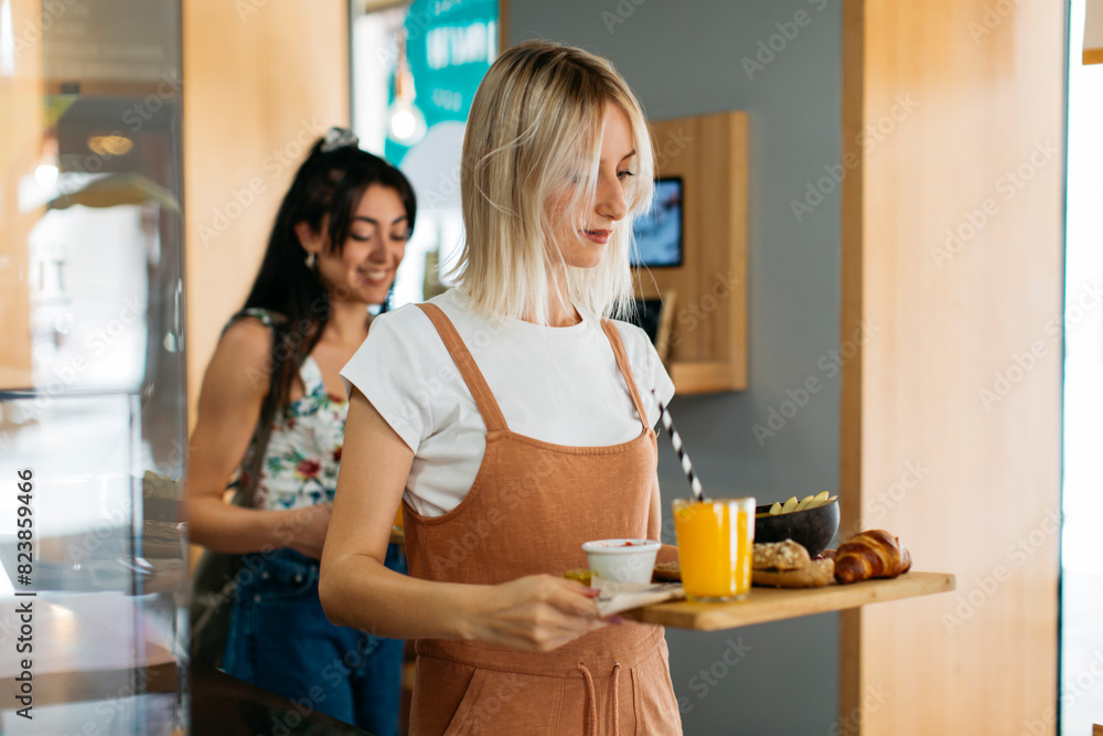 Two friends carrying their breakfast Two friends carrying their breakfast