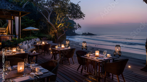 An elegant dining setup on a beachside deck at twilight, featuring candlelit tables with a serene view of the ocean, creating a romantic and tranquil atmosphere.