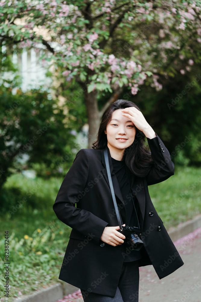 A smiling modern woman with a camera in her hands. A smiling modern woman with a camera in her hands.