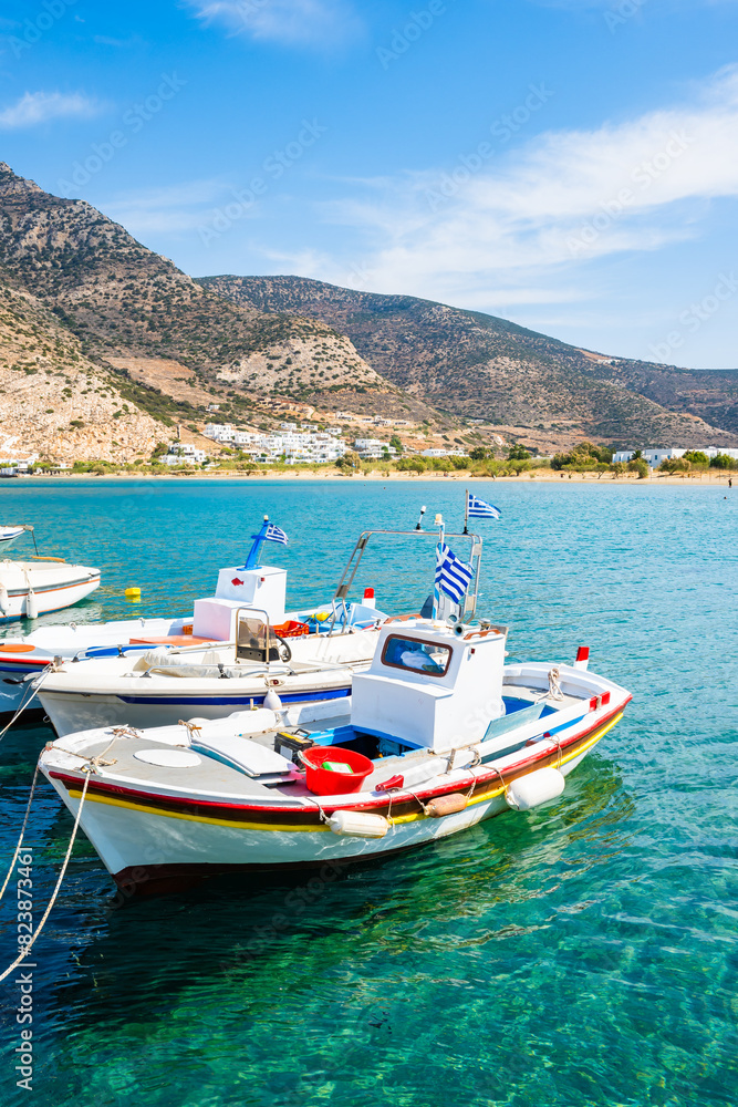 Traditional fishing boat anchoring in Kamares port, Sifnos island, Greece