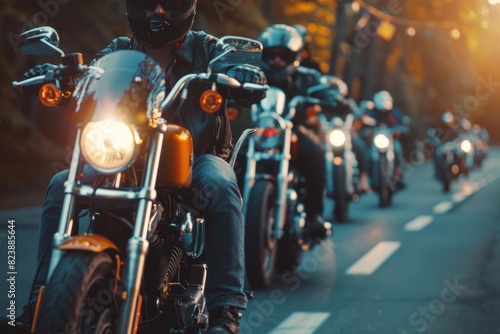 A group of people riding motorcycles down a street. Ideal for illustrating motorbike clubs or urban lifestyle © Fotograf