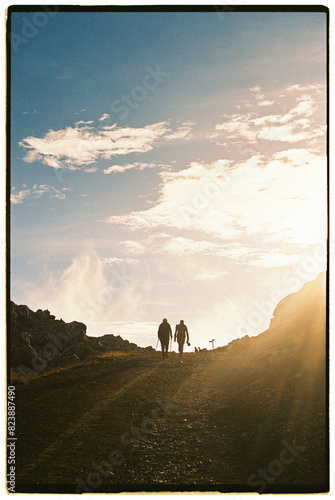 Shilouette of couple hiking at mountain landscape
 photo