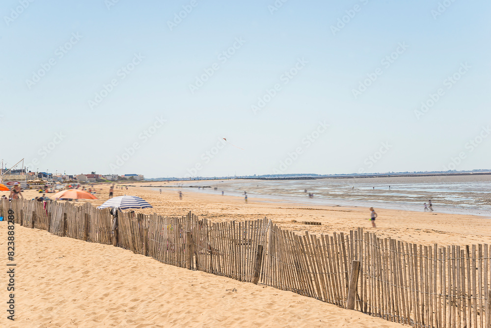 Summer beach holidays concept. Tourists in move on a beach Atlantic ocean Summer beach holidays concept. Tourists in move on a beach Atlantic ocean