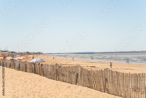 Summer beach holidays concept. Tourists in move on a beach Atlantic ocean
