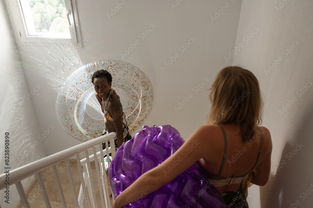 © Milles Studio/Stocksy - Happy women going out to the pool © Milles Studio/Stocksy - Happy women going out to the pool
