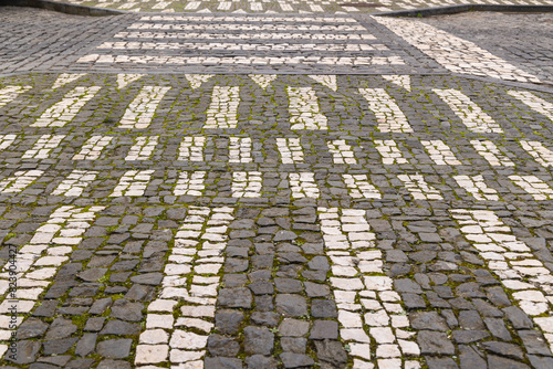 Black and white patterns in a cobble stone walkway.