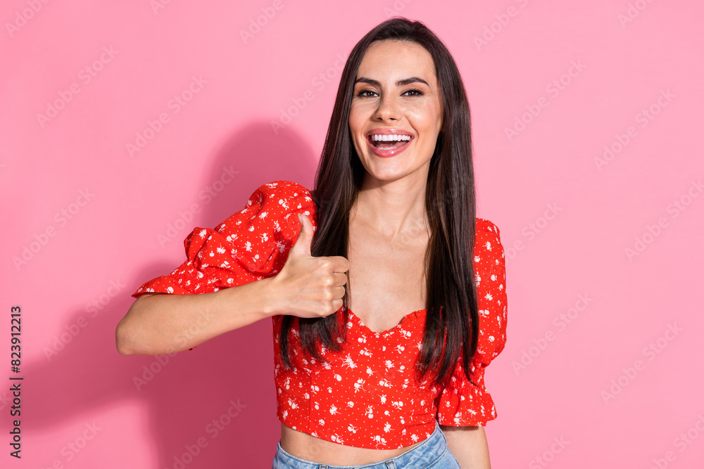 Photo of smiling beautiful gorgeous lovely young woman in retro red blouse laughing show like symbol isolated on pink color background Photo of smiling beautiful gorgeous lovely young woman in retro red blouse laughing show like symbol isolated on pink color background