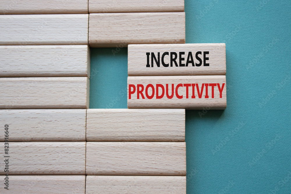 Increase Productivity symbol. Wooden blocks with words Increase Productivity. Businessman hand. Beautiful grey green background. Business and Increase Productivity concept. Copy space. Increase Productivity symbol. Wooden blocks with words Increase Productivity. Businessman hand. Beautiful grey green background. Business and Increase Productivity concept. Copy space.