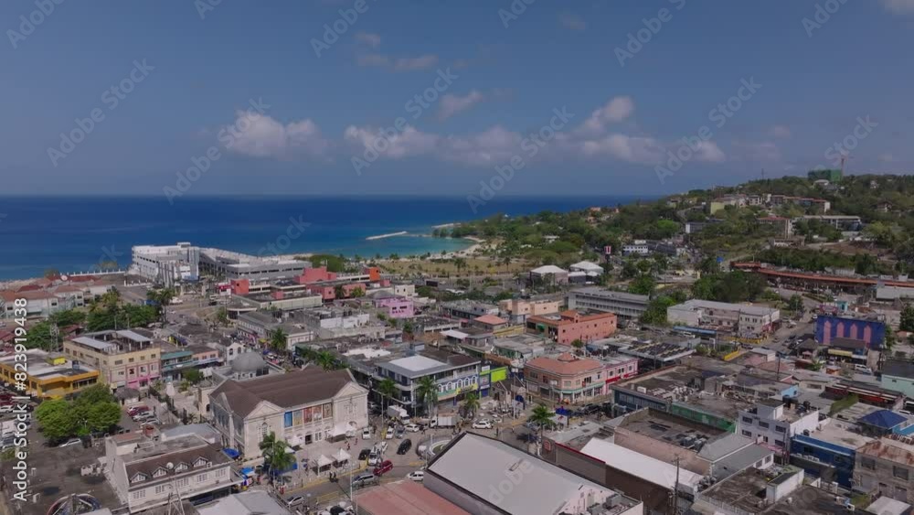 City of Montego Bay in the Jamaican coastline from a bird's eye view. Colorful buildings hug the shore against a stunning turquoise sea backdrop City of Montego Bay in the Jamaican coastline from a bird's eye view. Colorful buildings hug the shore against a stunning turquoise sea backdrop