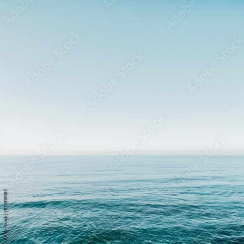 The image is of a calm ocean with a clear blue sky above