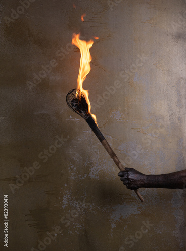 wooden fire torch in hand