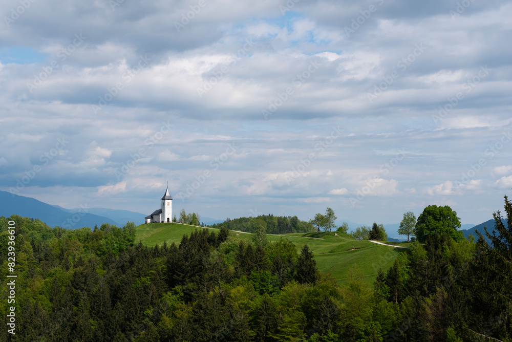 The white catholic church of St. Primoz in Jamnik on the top of green Slovenian mountains, Jamnik, Slovenia The white catholic church of St. Primoz in Jamnik on the top of green Slovenian mountains, Jamnik, Slovenia