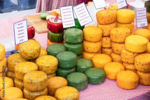 Various round cheeses displayed on a market stall in the Dutch cheese city of Alkmaar.