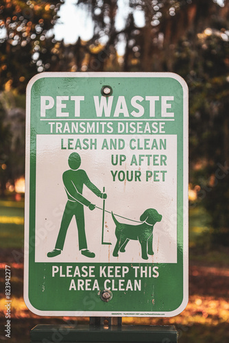Pet waste transmits disease leash and clean up after your pet sign in the park