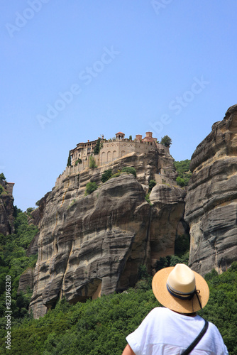 A tourist is looking to the Varlaam Monastery, Meteora monasteries - Greece