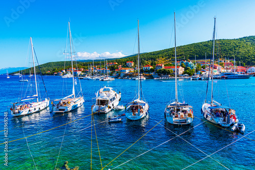 Fiskardo, Kefalonia, Greece: Panoramic view of the Fiskardo bay over the village and the boats ancored in the bay, Ionian island, Europe photo