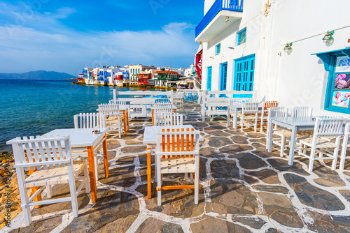 Mykonos, Greece: Waterfront with tables in typical Greek tavern in Little Venice part of Mykonos town, Mykonos island, Greece, Europe
