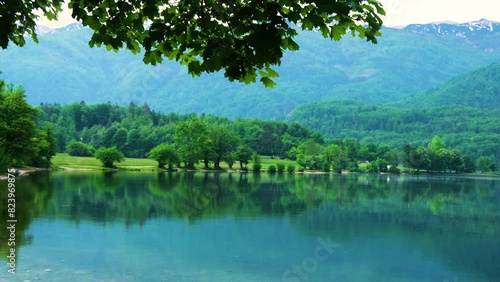 Rain on Bohinj lake beautiful green alpine mountain lake with crystal clear water in spring, Slovenia, Europe photo